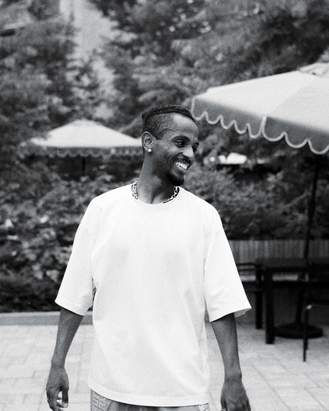 Meni smiling outdoors at a DC street photographer meetup, July 2026.
